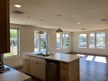 La Crosse apartment for rent - A kitchen with a large island and a stove top oven.