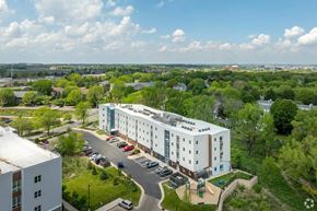 Madison apartment for rent - A large white building with a parking lot in front of it.