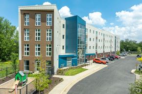 Madison apartment for rent - A modern building with a playground in front.