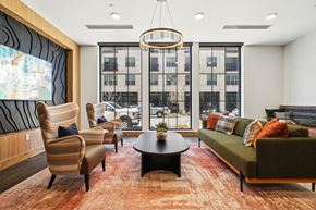 Denver apartment for rent - A living room with a large window and a view of the city.