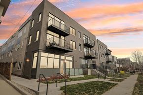 Denver townhouse for rent - A modern apartment building with balconies and a walkway in front.