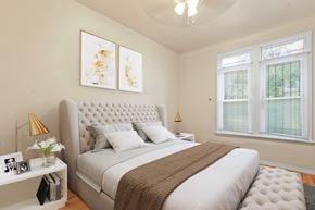 Denver apartment for rent - a bedroom with a large bed and two windows