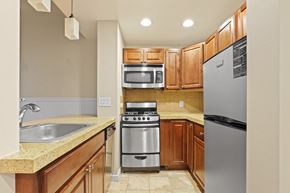 Denver apartment for rent - a kitchen with wooden cabinets and stainless steel appliances