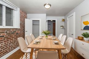 Denver apartment for rent - A dining room with a long table and chairs.