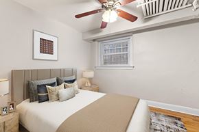 Denver apartment for rent - a bedroom with a bed and a ceiling fan