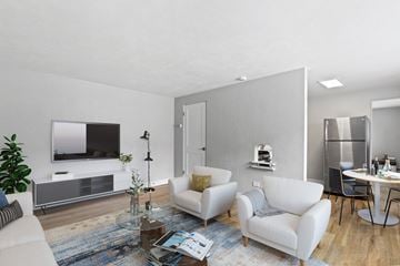Denver apartment for rent - a living room with white furniture and a tv