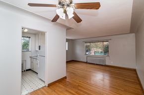 Denver apartment for rent - A room with a ceiling fan and wooden floors.