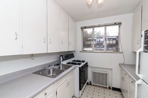Denver apartment for rent - A white kitchen with a window overlooking a parking lot.