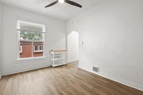 Denver apartment for rent - A room with a window and a fan on the ceiling.