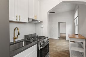 Denver apartment for rent - A kitchen with a stove, sink, and cabinets.