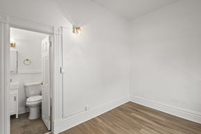 Denver apartment for rent - A white bathroom with a toilet and sink.
