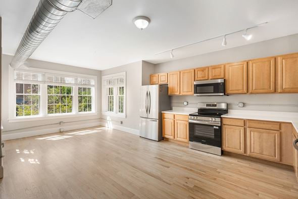 Denver apartment for rent - A kitchen with wooden cabinets and stainless steel appliances.