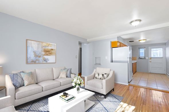 Denver apartment for rent - A living room with a white couch and a painting on the wall.