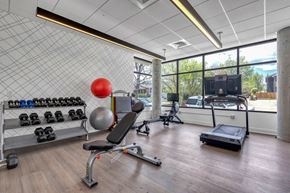 Denver apartment for rent - a workout room with a treadmill and weights