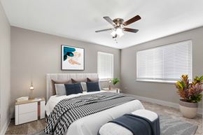 Denver apartment for rent - a bedroom with a bed and a ceiling fan