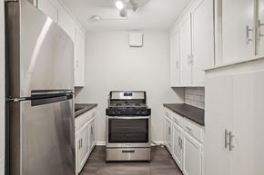 Denver apartment for rent - A kitchen with white cabinets and a stainless steel refrigerator.