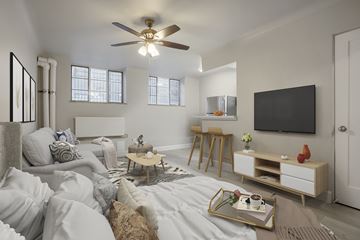 Denver apartment for rent - A living room with a white couch and a wooden coffee table.