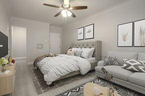 Denver apartment for rent - A bedroom with a large bed, a couch, and a ceiling fan.