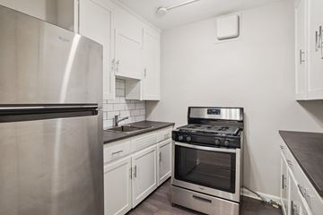 Denver apartment for rent - A modern kitchen with a stainless steel refrigerator and a stove top oven.