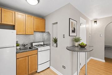 Denver apartment for rent - A kitchen with a white refrigerator and a white stove.