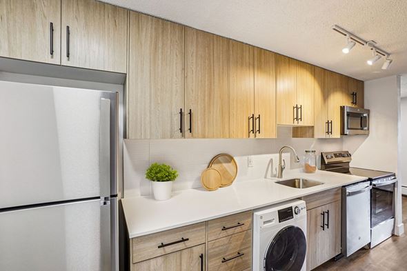 Denver apartment for rent - A modern kitchen with wooden cabinets and stainless steel appliances.