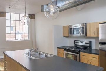 Denver apartment for rent - A kitchen with a stove, sink, and cabinets.