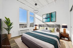 Denver apartment for rent - A bedroom with a large bed and a flat screen TV.