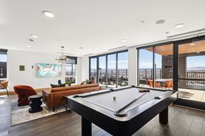 Denver apartment for rent - A pool table is in the middle of a room with a view of the ocean.
