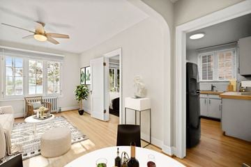Denver apartment for rent - a living room and a kitchen with a table and a ceiling fan