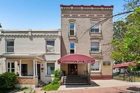 Denver apartment for rent - A building with a red awning that says "Governor's Park West.".