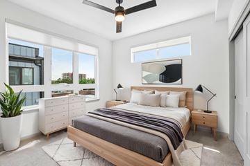 Denver townhouse for rent - A bedroom with a large bed and a ceiling fan.