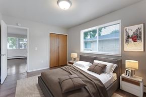 Denver apartment for rent - A bedroom with a bed, nightstand, and a painting on the wall.