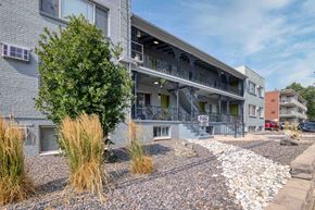 Denver apartment for rent - a building with a porch and a tree in front of it