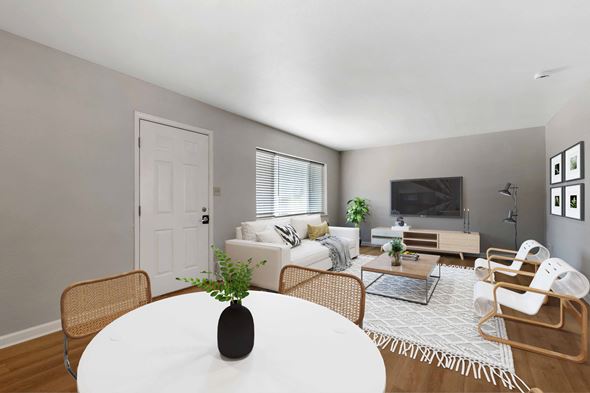 Denver apartment for rent - a living room with a white table and a couch and a tv