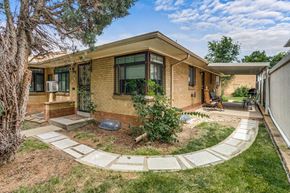 Denver apartment for rent - A house with a brown brick exterior and a white roof.
