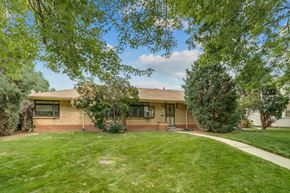 Denver apartment for rent - A house with a green lawn and trees in the front yard.
