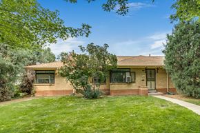 Denver apartment for rent - A house with a brown roof and a green lawn in front.