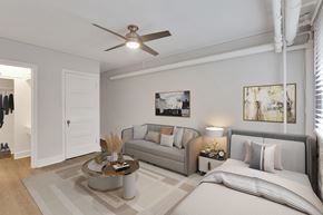Denver apartment for rent - A well-lit bedroom with a bed, couch, and a ceiling fan.