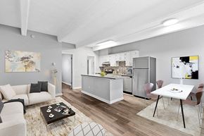 Denver apartment for rent - A modern kitchen with a dining table and chairs.