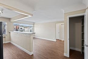 Denver apartment for rent - A room with a bar area and a view of the outside.