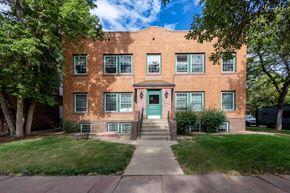 Denver apartment for rent - the front of a brick apartment building with a green door