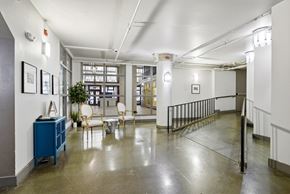 Denver apartment for rent - A room with a blue cabinet and a white chair.