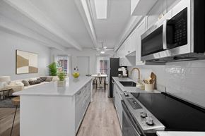 Denver apartment for rent - A modern kitchen with a white island and stainless steel appliances.