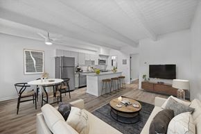 Denver apartment for rent - A modern living room with a kitchen in the background.