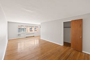 Denver apartment for rent - A room with a wooden floor and a door on the right side.