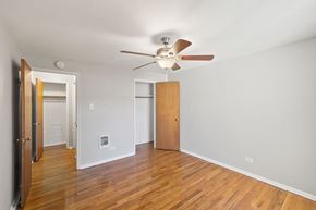 Denver apartment for rent - A room with a ceiling fan and wooden floors.