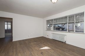 Denver apartment for rent - A room with a window and a radiator on the wall.