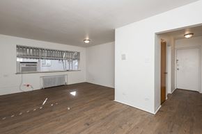 Denver apartment for rent - A room with wooden floors and white walls.