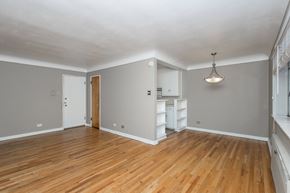 Denver apartment for rent - A room with wooden floors and white walls.