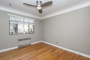 Denver apartment for rent - A room with a ceiling fan and a window with blinds.